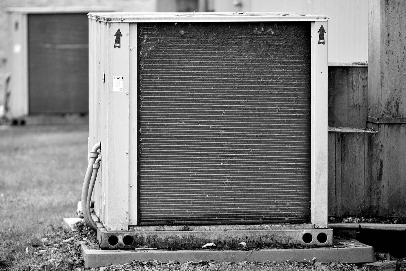 Black and white photograph of an outdoor HVAC unit, used as illustrative equipment imagery